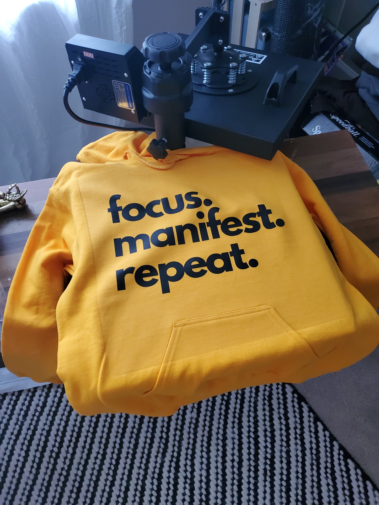 Gold hoodie focus manifest repeat